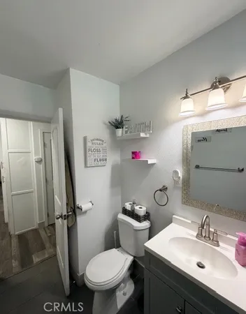 a bedroom with a bed and a refrigerator