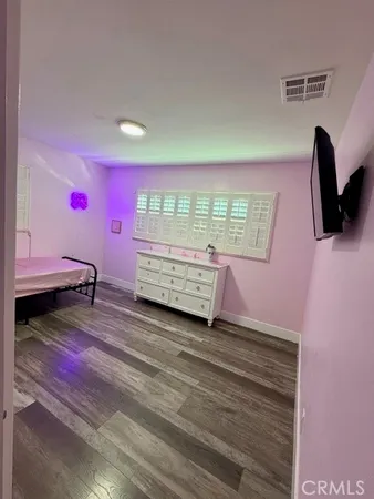 a view of a hallway with wooden floor and entryway