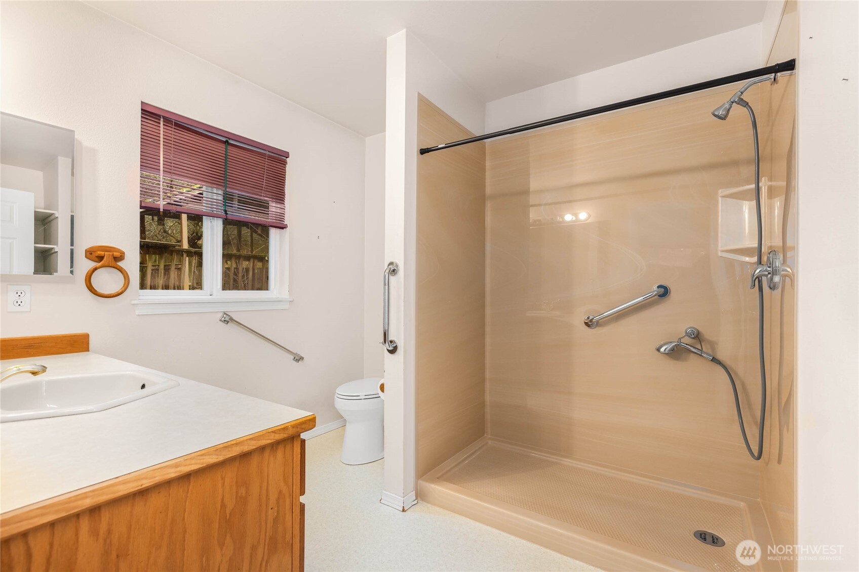 14638 Gibralter Road Anacortes, WA 98221 - Photo 12 of 25 a bathroom with a shower sink and mirror