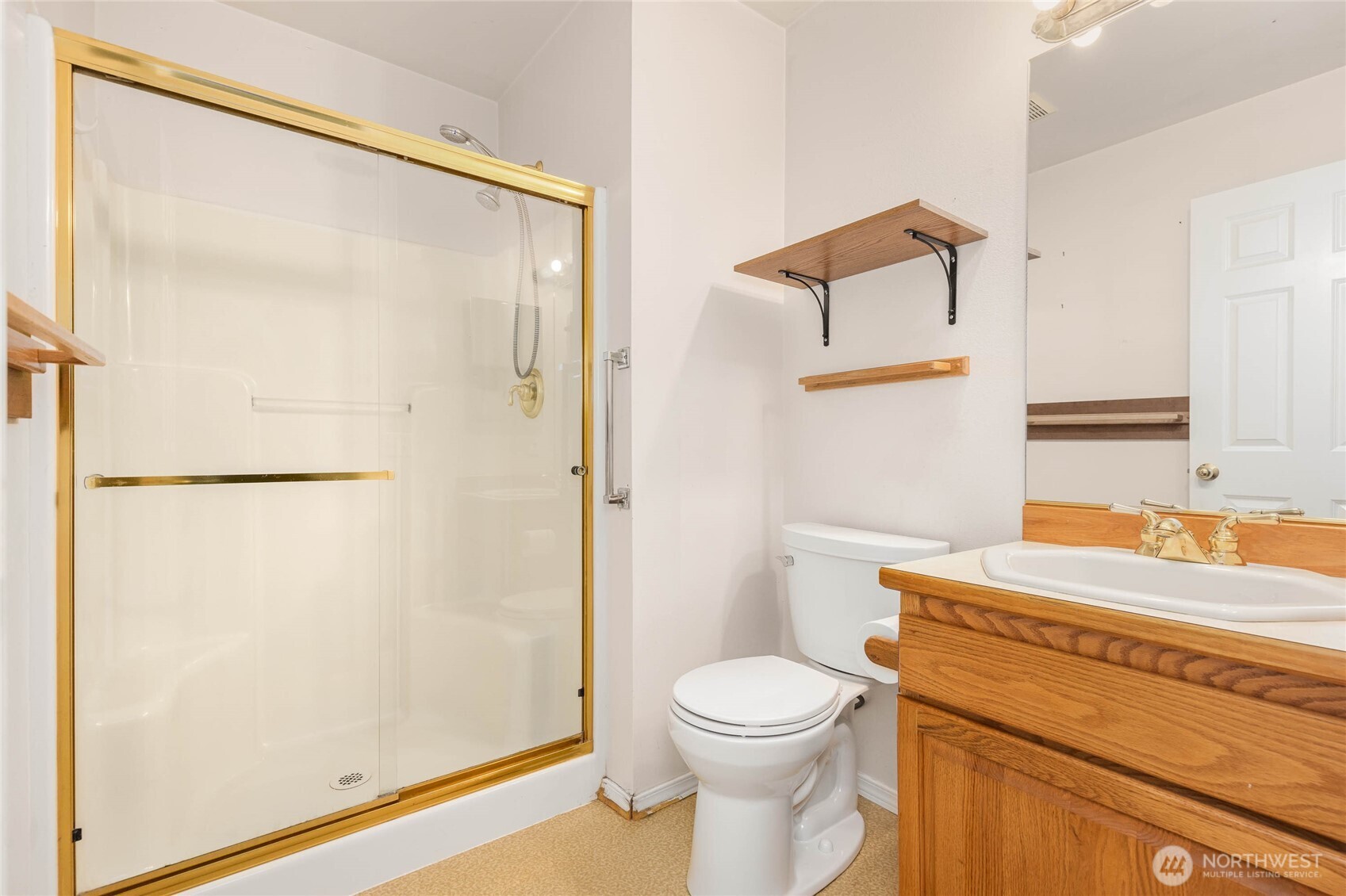 14638 Gibralter Road Anacortes, WA 98221 - Photo 14 of 25 a bathroom with a toilet a sink and a shower