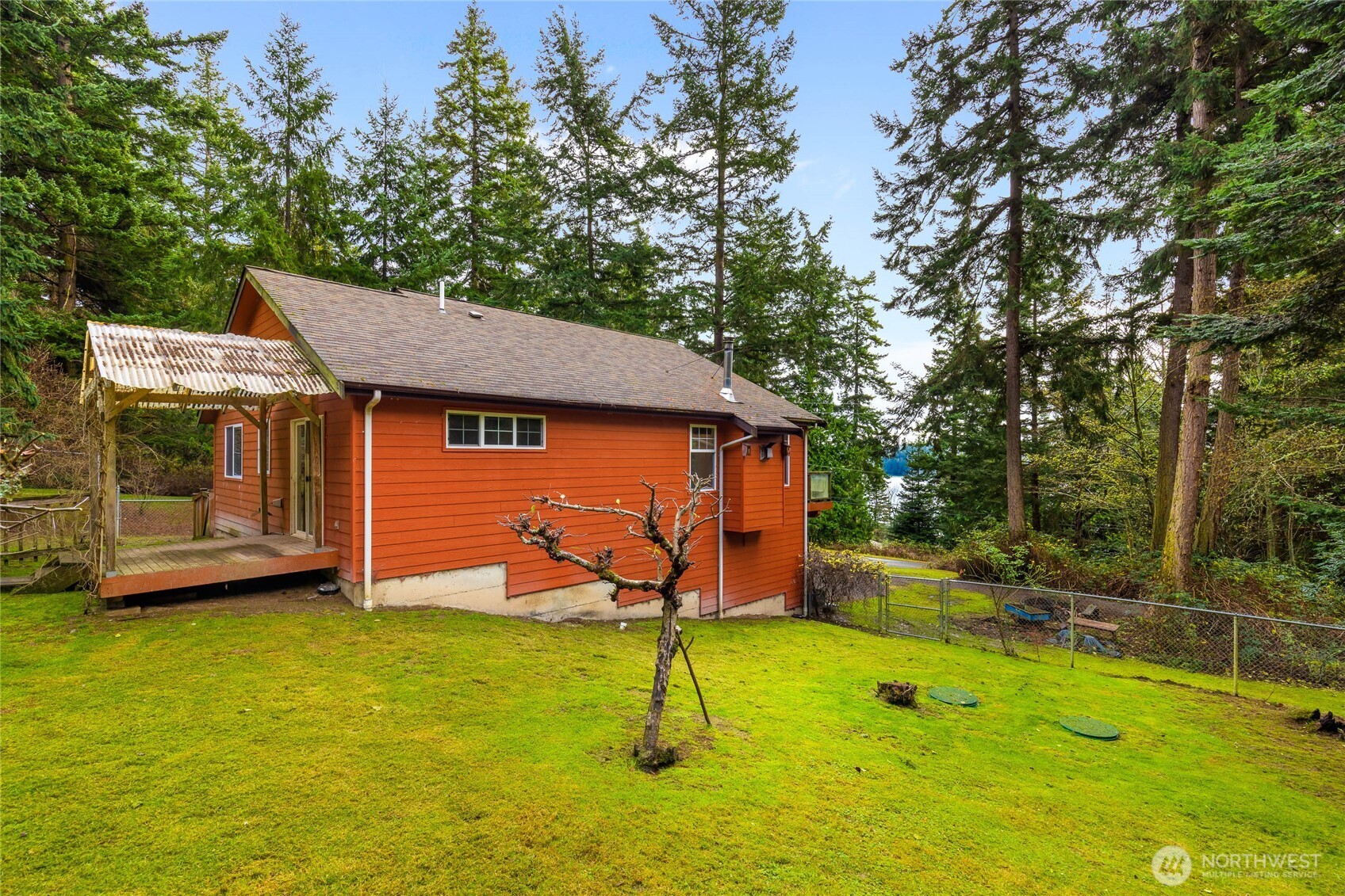 14638 Gibralter Road Anacortes, WA 98221 - Photo 23 of 25 a backyard of a house with a swing table and chairs