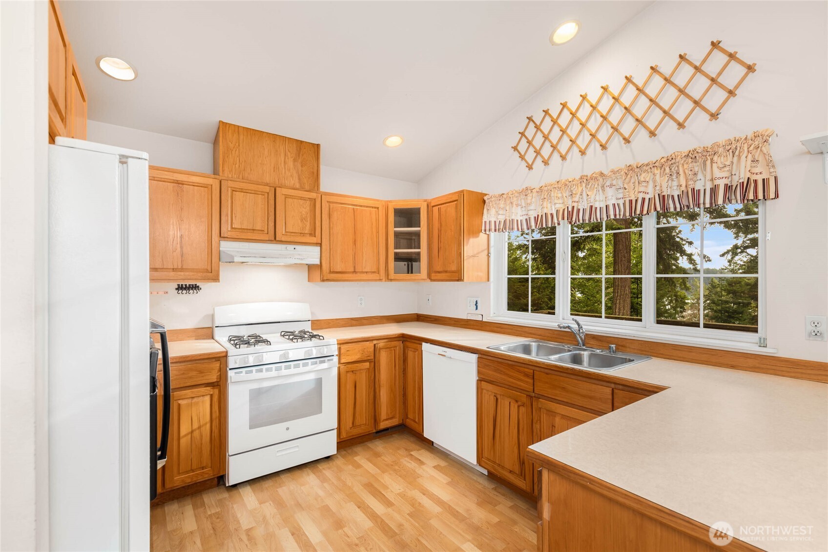 14638 Gibralter Road Anacortes, WA 98221 - Photo 9 of 25 a kitchen with stainless steel appliances a sink a stove and a refrigerator