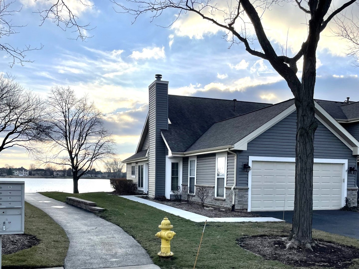 1068 Ridgefield Circle Carol Stream, IL 60188 - Photo 1 of 15 a front view of a house with garden