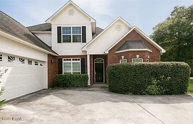 104 Tranquill Pointe, Unit POINTE Warner Robins, GA 31088 - Photo 2 of 8 a front view of a house with garden