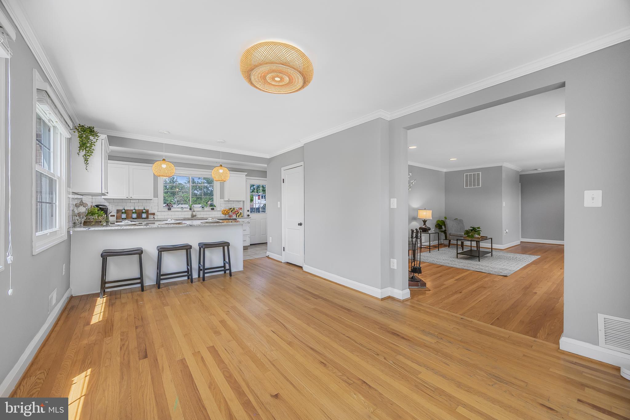 1305 Heather Hill Road Baltimore, MD 21239 - Photo 12 of 50 Spacious kitchen w/ white cabinets & hardwood flrs