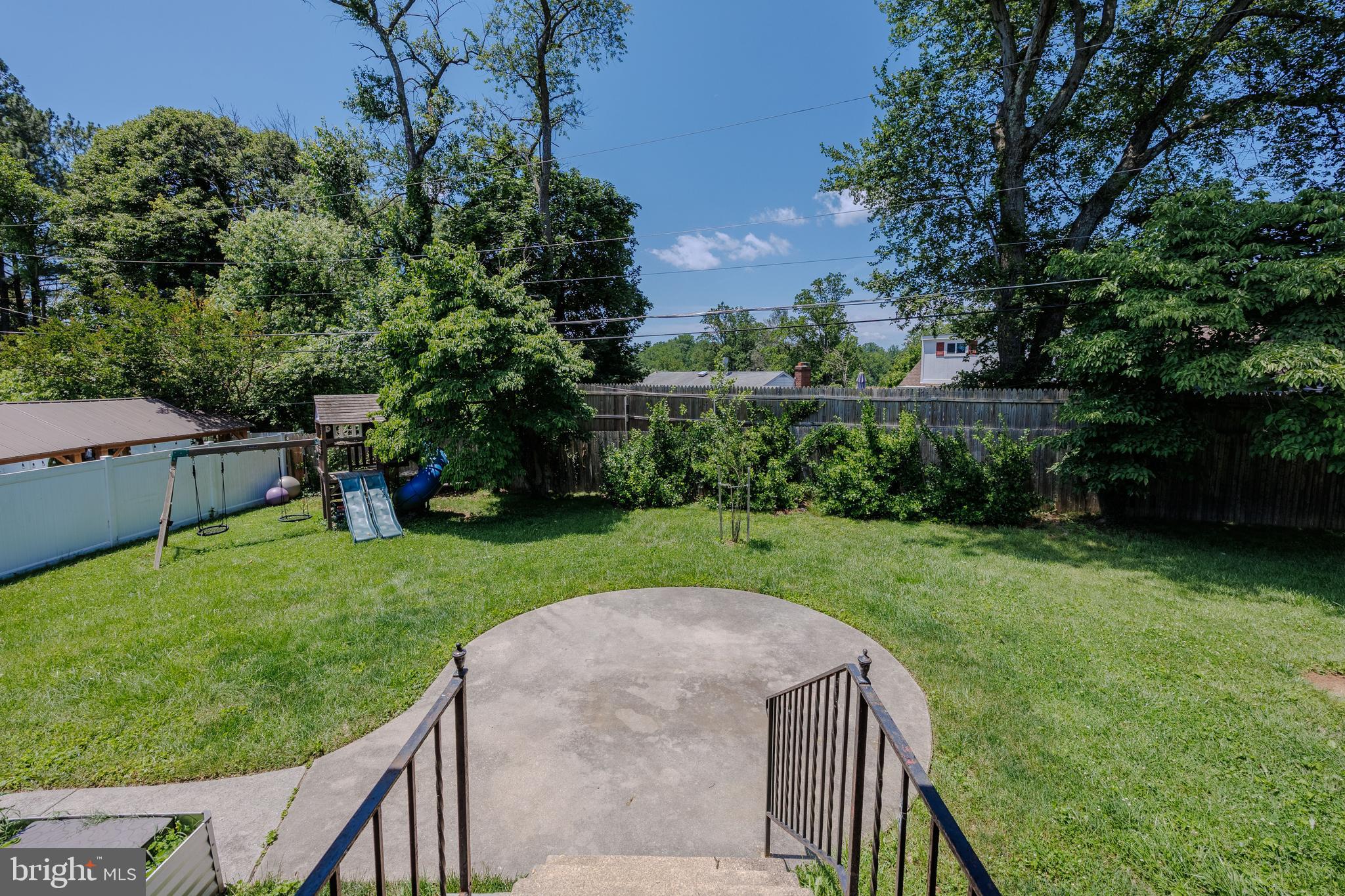 1305 Heather Hill Road Baltimore, MD 21239 - Photo 41 of 50 backyard with a playset, a pathway, and greenery