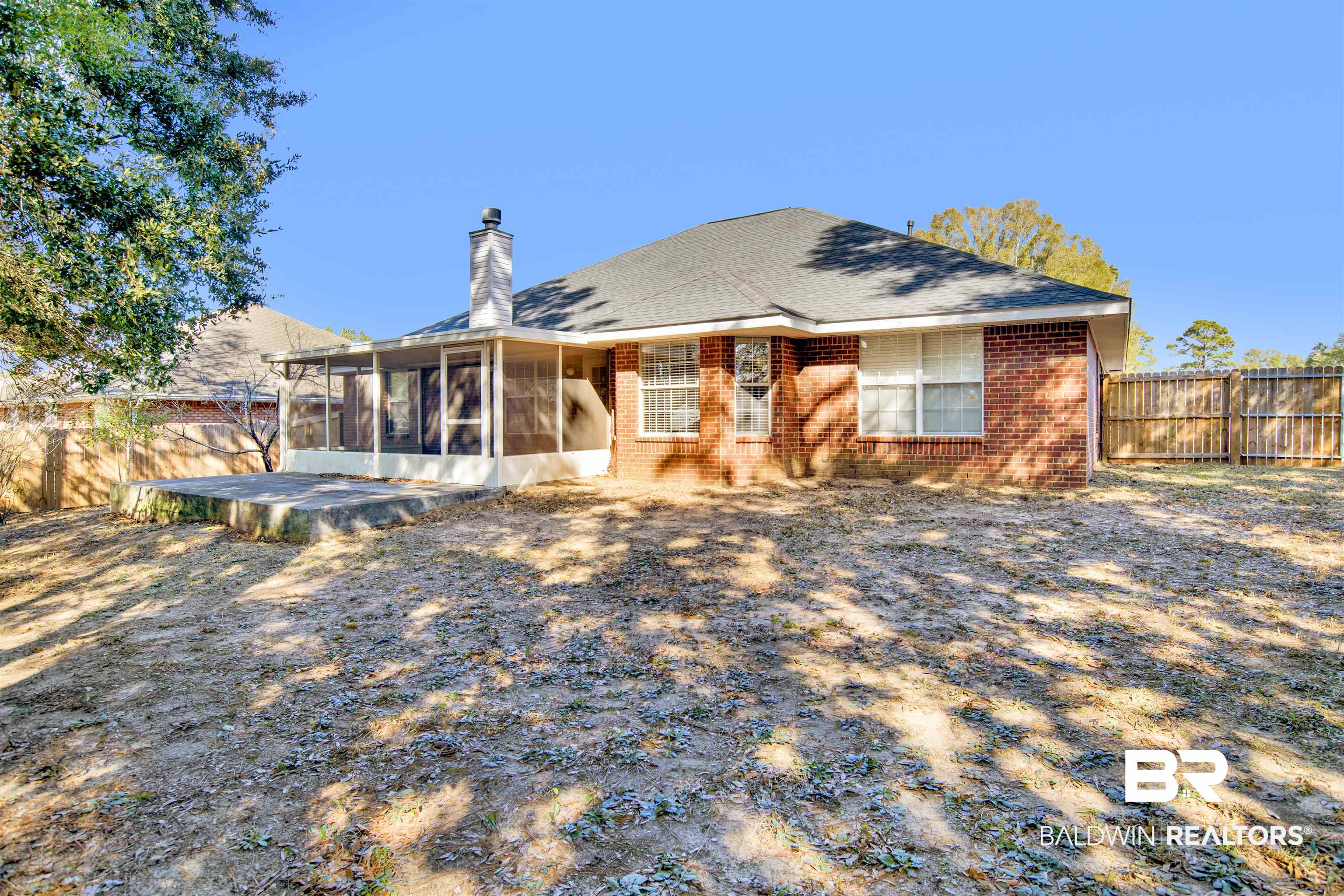 7297 Bridgemill Drive Mobile, AL 36619 - Photo 29 of 33 Rear view of property with a sunroom, brick siding, a chimney, and roof with shingles