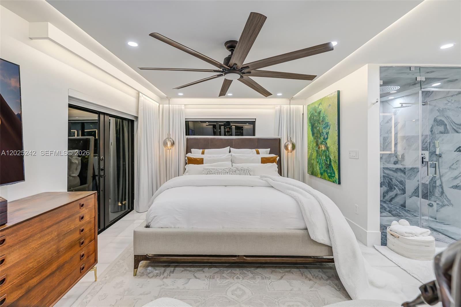 8761 Southwest 56th Street Miami, FL 33165 - Photo 47 of 90 a spacious bedroom with a bed and a chandelier