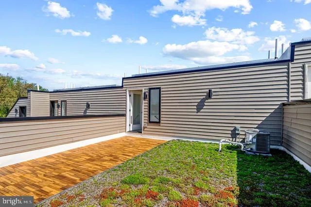 a view of a sign board with buildings in the background