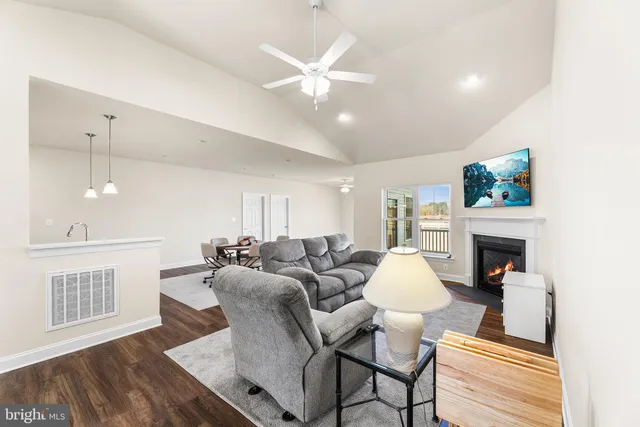 a living room with furniture a fireplace and a chandelier