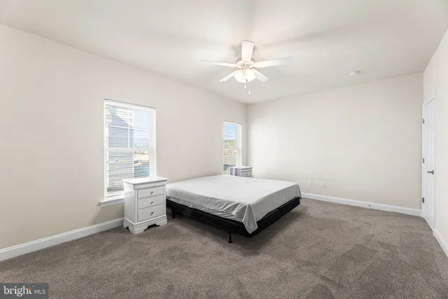 a living room with a bed and a window