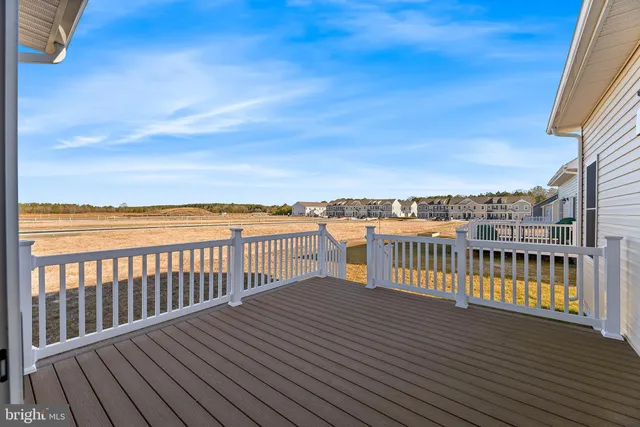 a view of a roof deck with wooden floor and fence