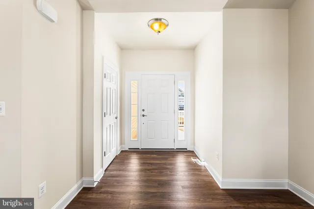 a view of hallway with wooden floor