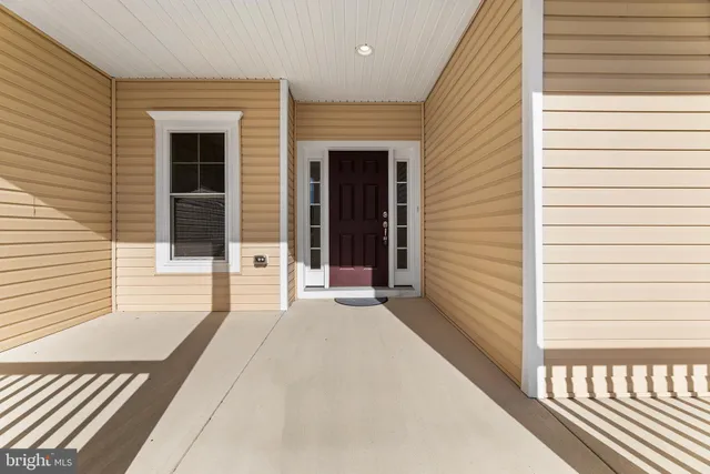 a view of a balcony with a door and wooden floor
