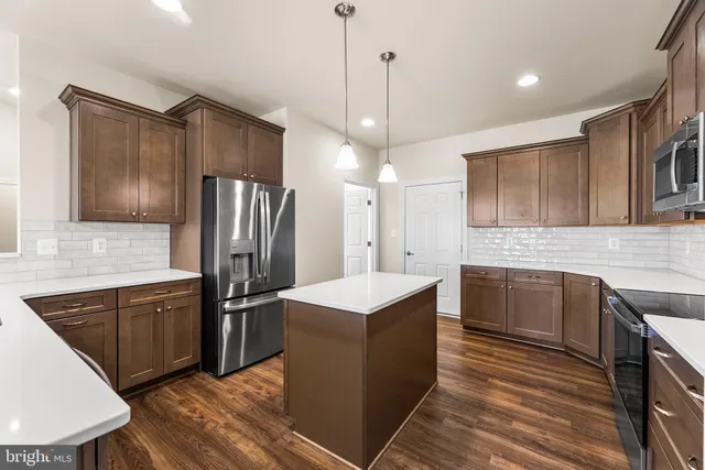 a kitchen that has a sink stainless steel appliances a counter space and cabinets