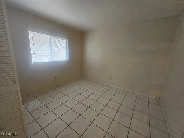 a bathroom with a granite countertop sink mirror vanity and toilet