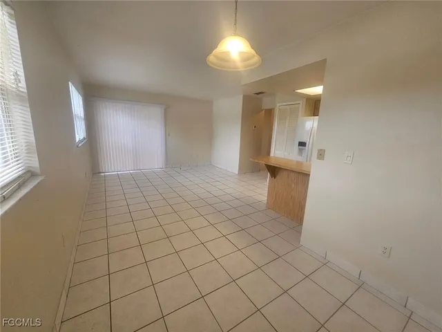 a kitchen with stainless steel appliances granite countertop a sink a stove a refrigerator and cabinets