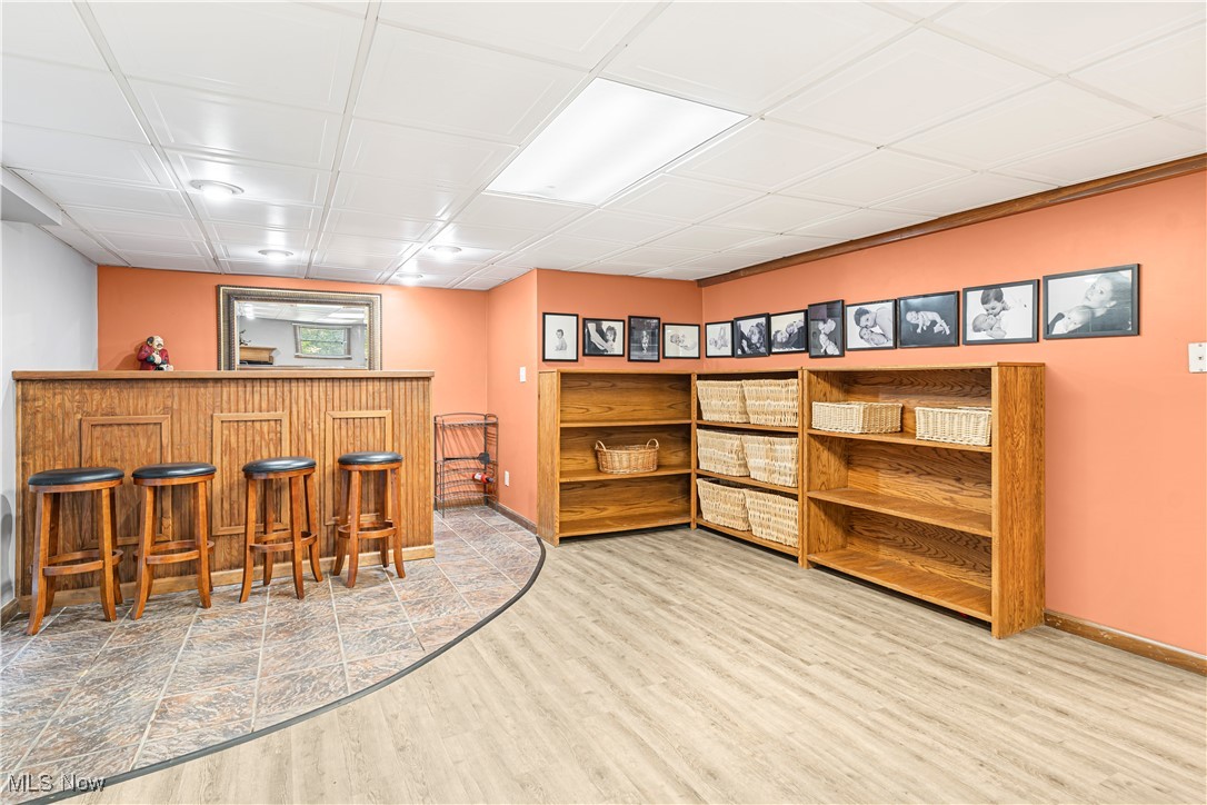 155 Ridgewood Boulevard Belpre, OH 45714 - Photo 29 of 49 Indoor dry bar with light wood-style flooring and brown cabinetry