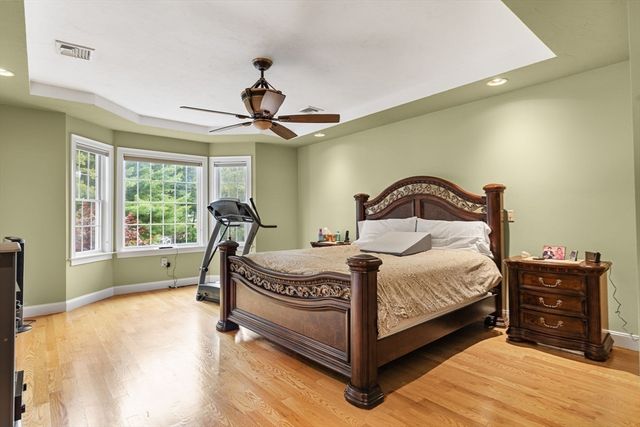 a bedroom with a bed window and a ceiling fan