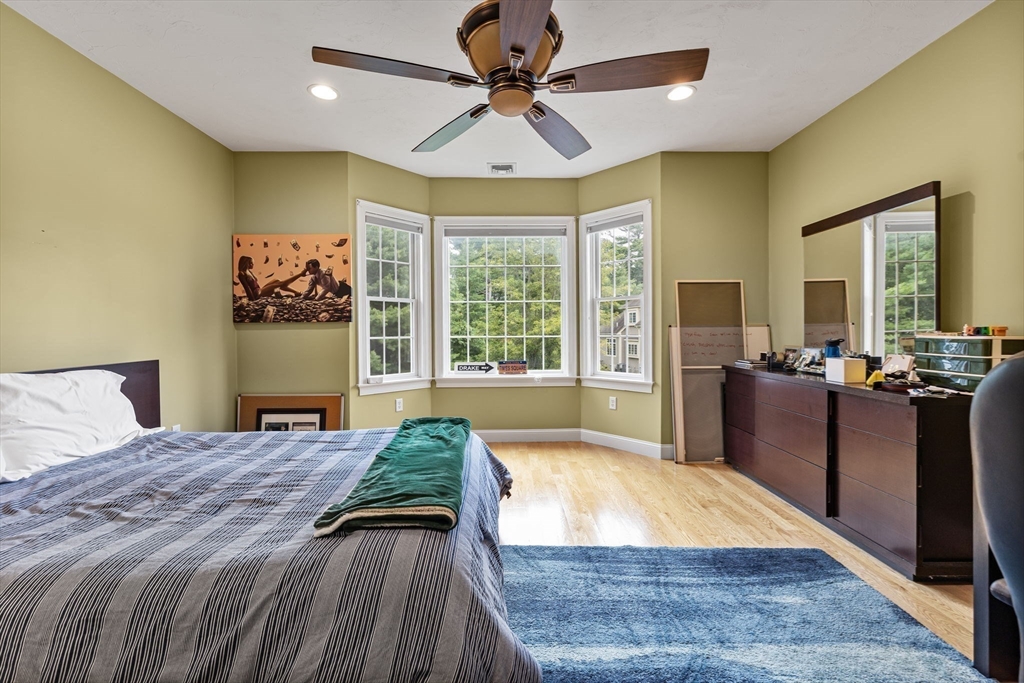6 Ashley Court Lynnfield, MA 01940 - Photo 20 of 41 a spacious bedroom with a bed and a chandelier