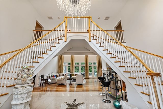 a view of staircase with lots of frames on and white walls