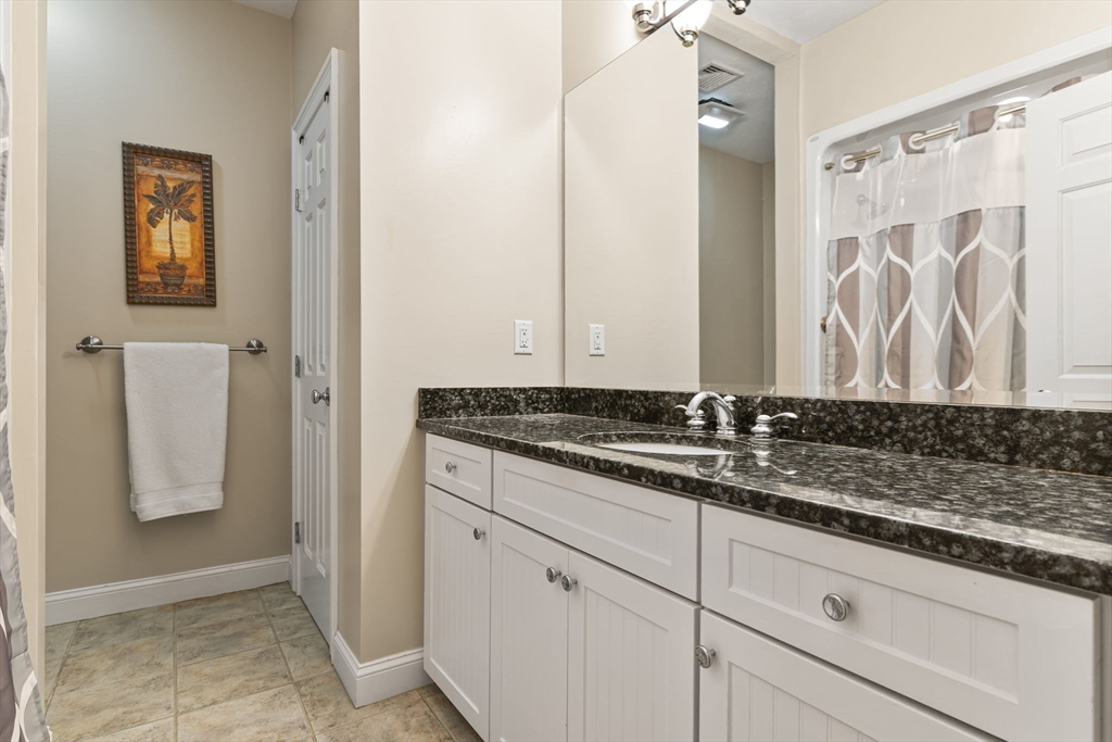 6 Ashley Court Lynnfield, MA 01940 - Photo 23 of 41 a bathroom with a granite countertop sink and a mirror
