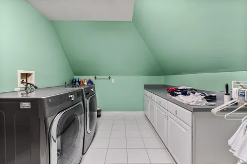 a utility room with sink dryer and washer