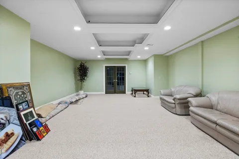 a bedroom with furniture and a large window