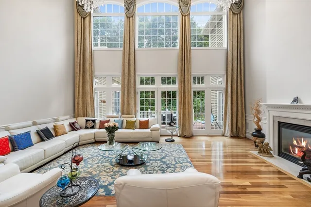 a living room with furniture large window and a fireplace