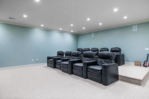a media room with lots of chairs and a projector screen