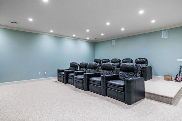a media room with lots of chairs and a projector screen
