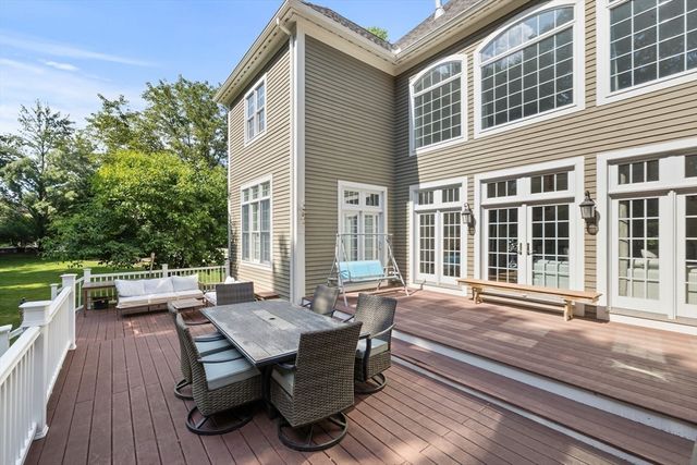 a view of a house with backyard sitting area and garden
