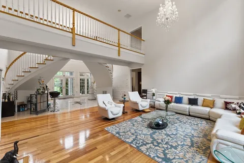 a living room with furniture and a chandelier