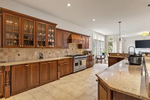 a large kitchen with stainless steel appliances and a large window
