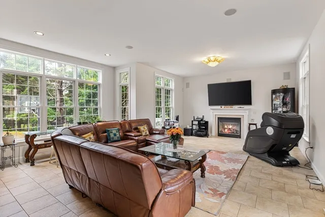 a living room with furniture windows and a flat screen tv