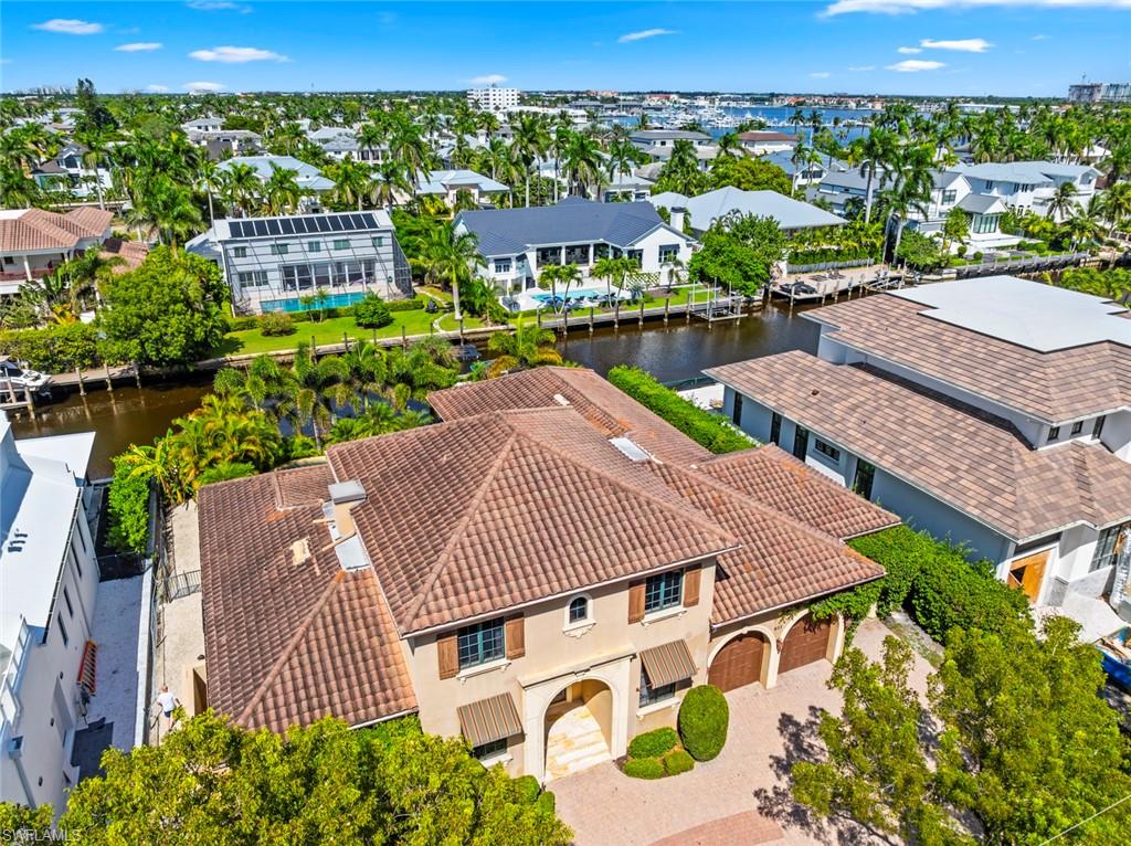 611 18th Avenue South Naples, FL 34102 - Photo 43 of 44 Aerial perspective of suburban area featuring a large body of water