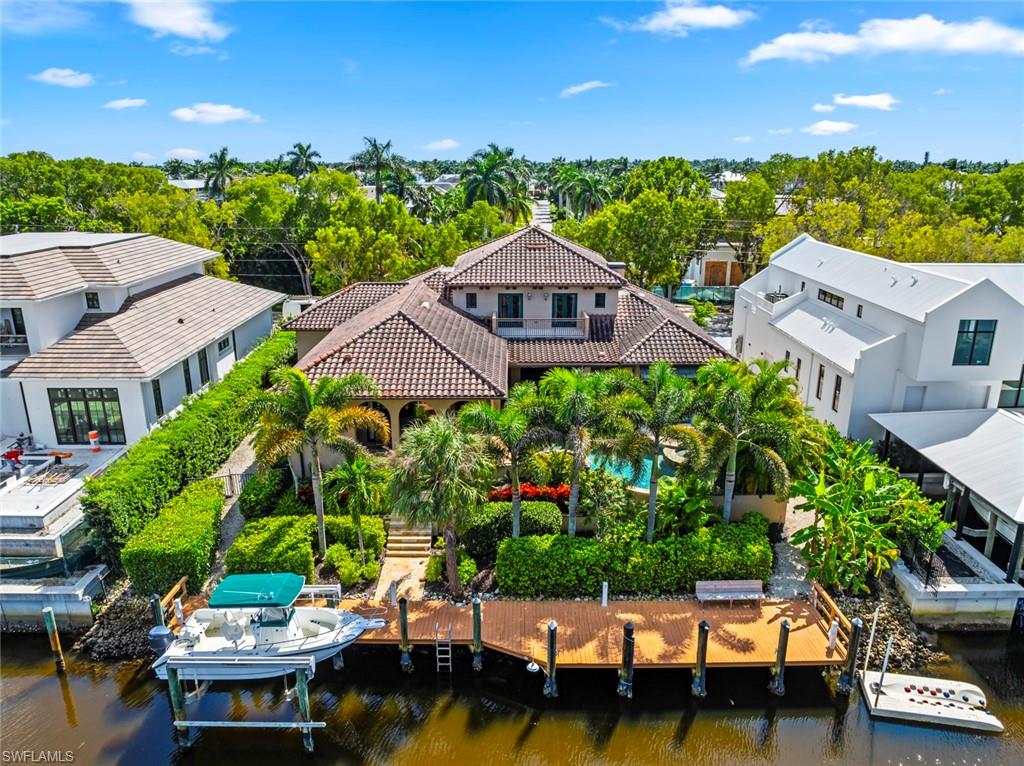 611 18th Avenue South Naples, FL 34102 - Photo 44 of 44 View from above of property with a tree filled landscape
