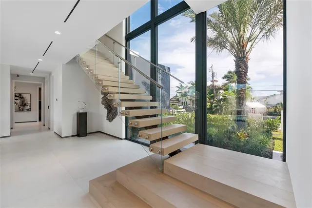 a living room with furniture and a floor to ceiling window