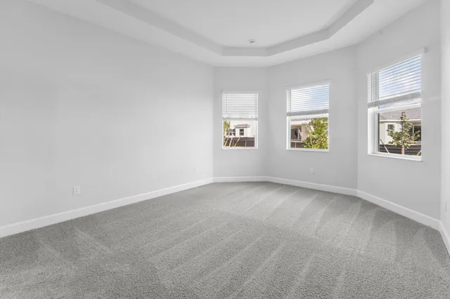 a view of a room with wooden floor and white walls