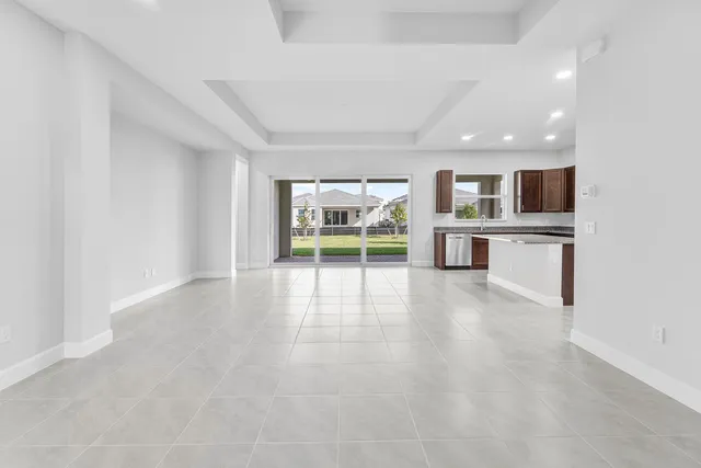 a view of kitchen with kitchen island a sink stainless steel appliances and cabinets