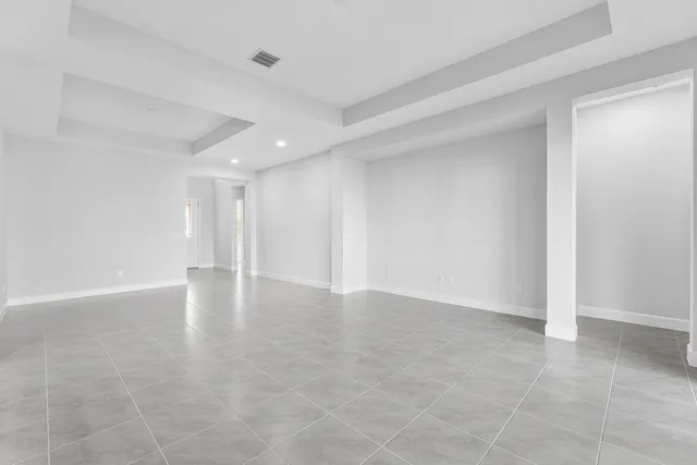 a large kitchen with stainless steel appliances granite countertop a stove a sink and a refrigerator