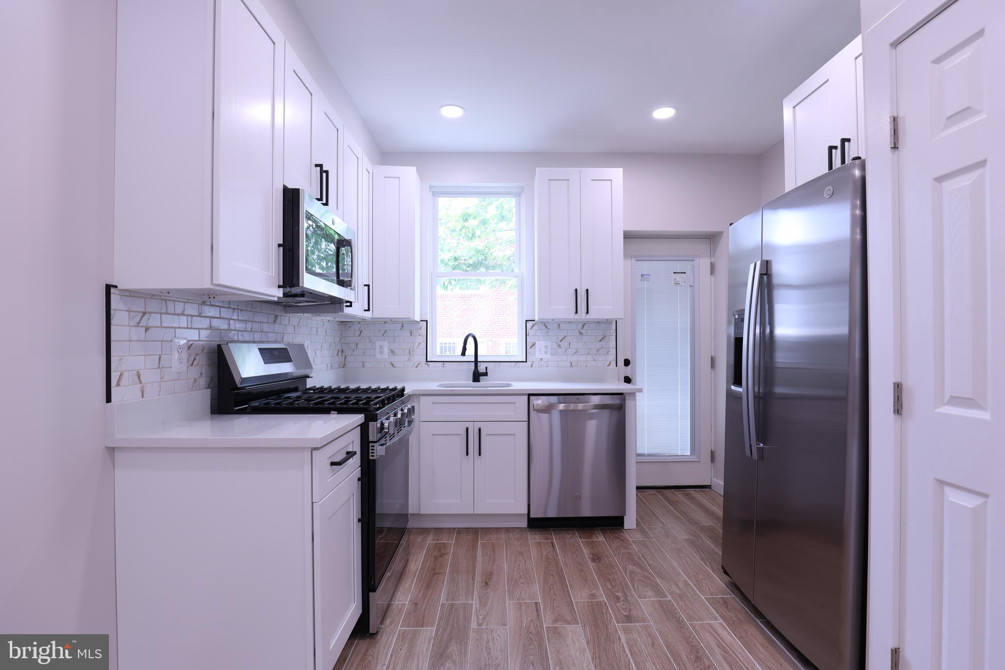 2039 Rosedale Street Northeast Washington, DC 20002 - Photo 3 of 18 a kitchen with a sink stove and refrigerator