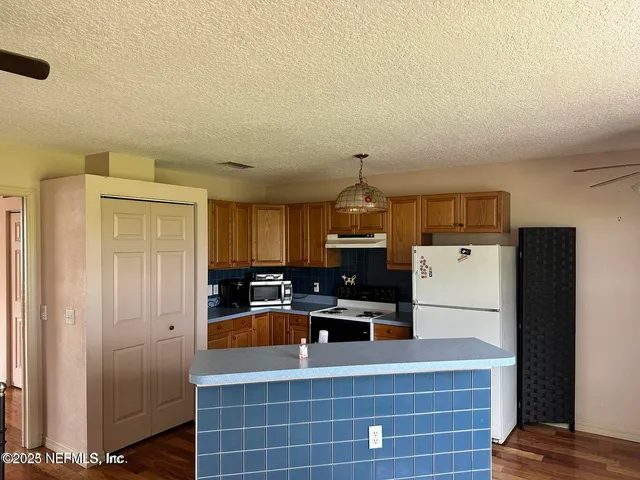 a kitchen with refrigerator and cabinets