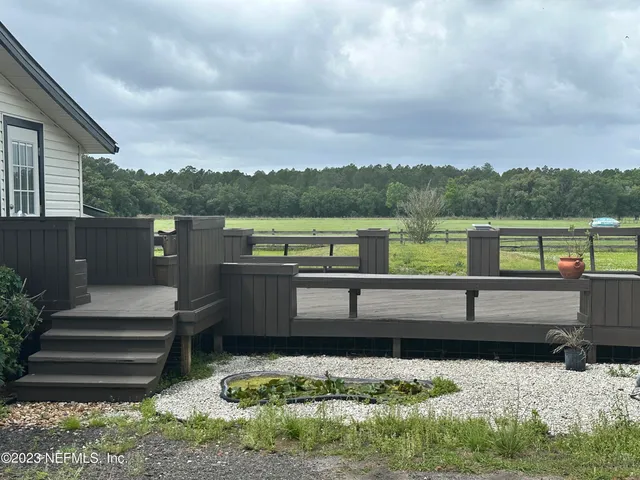 a view of outdoor space with deck and yard