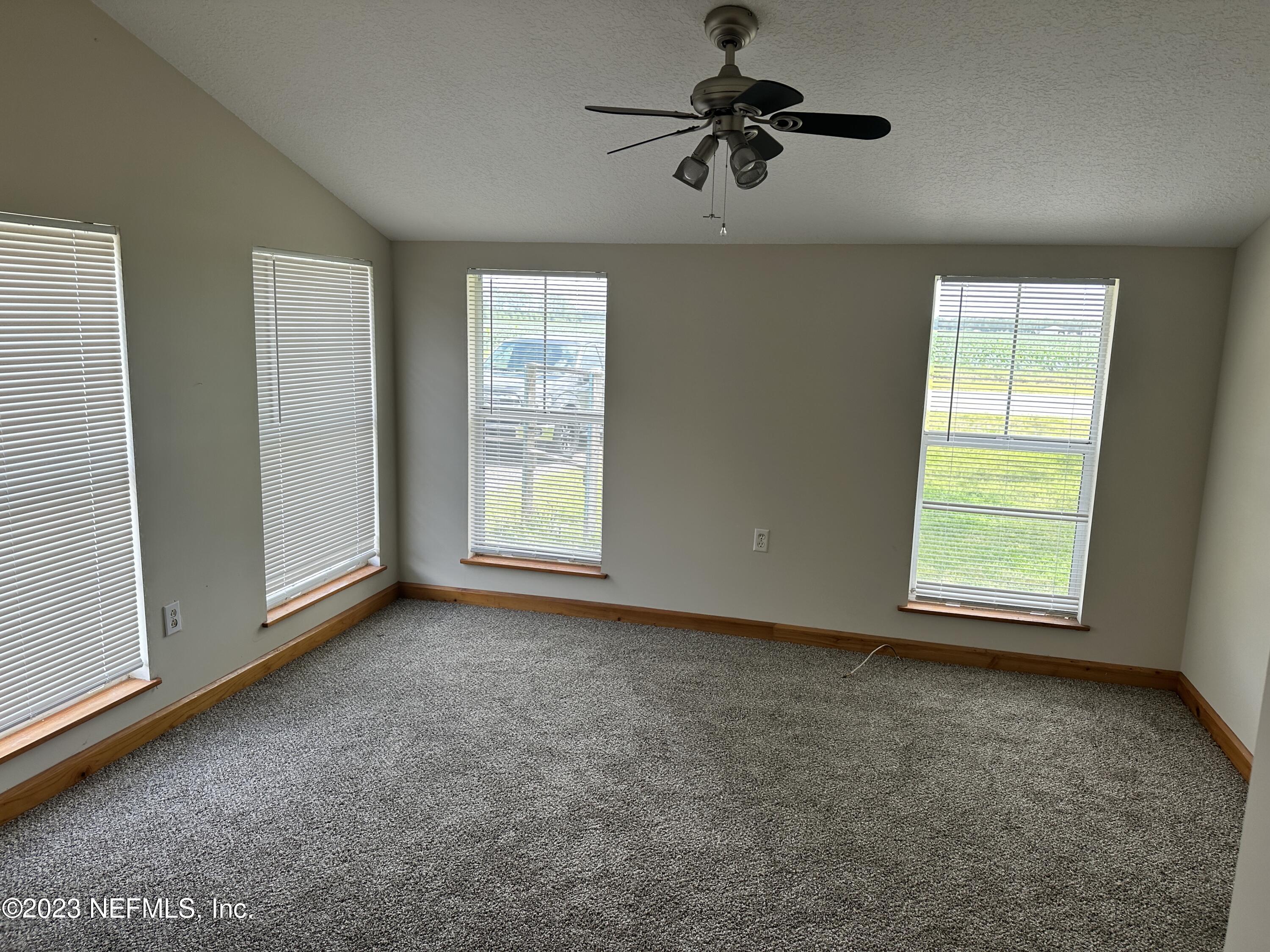 9465 Cowpen Branch Road, Unit A Hastings, FL 32145 - Photo 7 of 21 an empty room with windows and fan