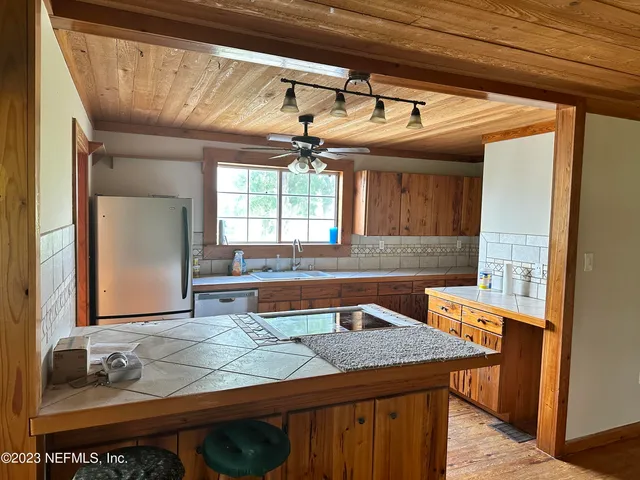 a kitchen with a sink and a refrigerator