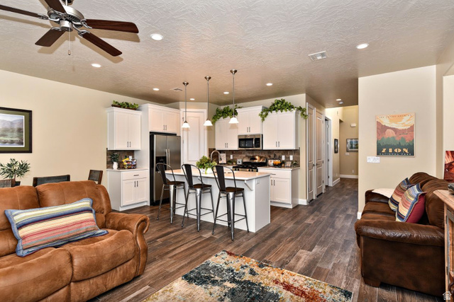 1622 Canyon Tree Drive St. George, UT 84770 - Photo 5 of 34 Open-concept living area featuring wood-finish flooring, recessed lighting, and a ceiling fan