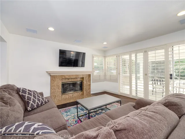 a living room with furniture fireplace and window