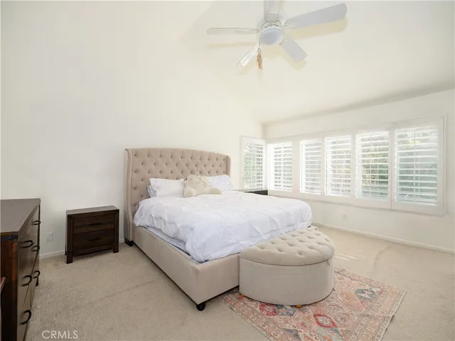 a spacious bedroom with a bed and a large window