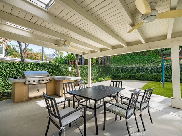 a view of an outdoor dining space with a table and chairs